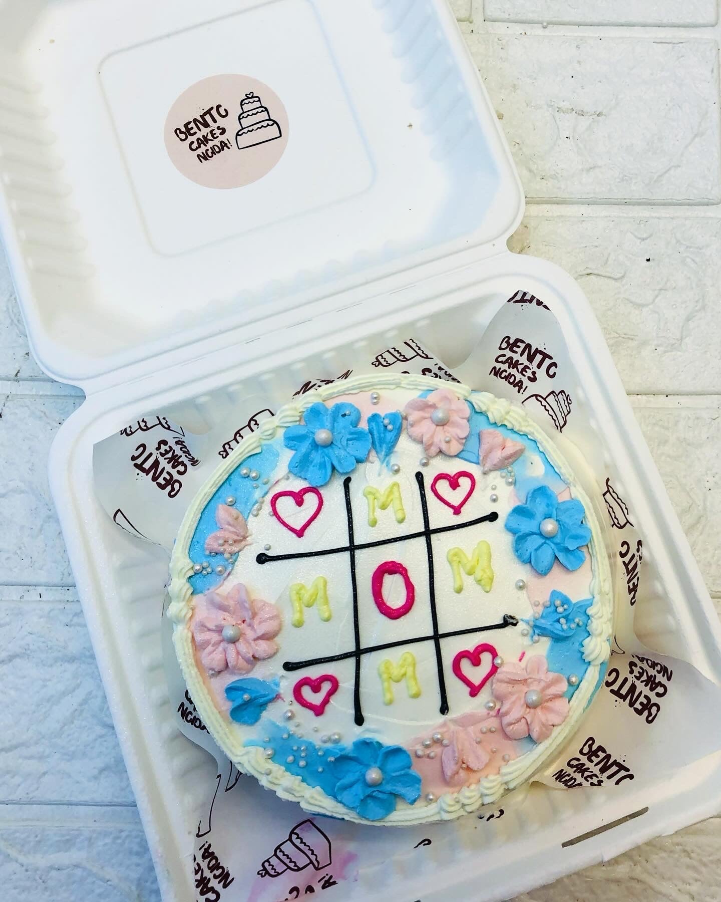An aesthetic floral design cake having tic tak shape for mothers day.