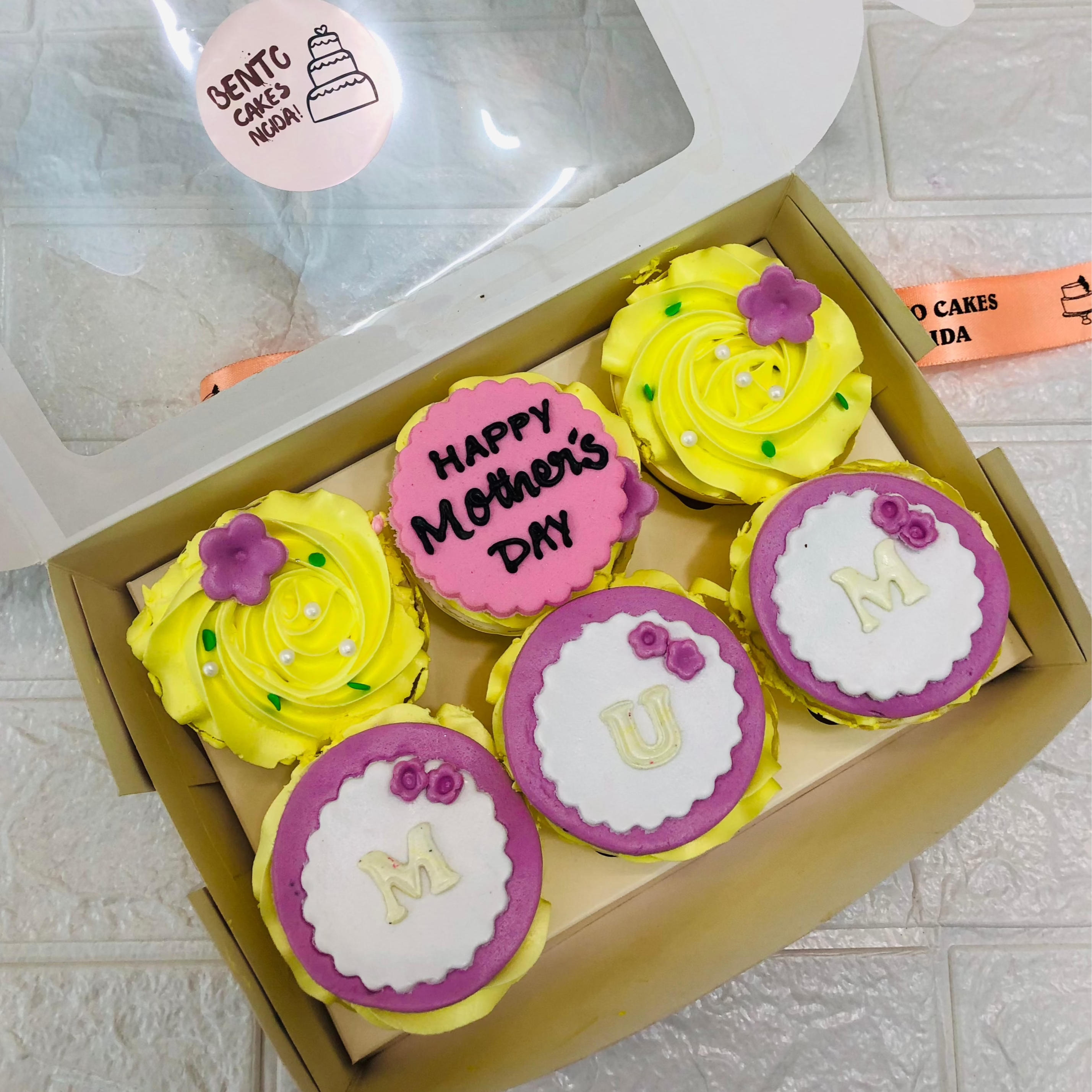 A box having 6 different designs cupcakes for mothers day.